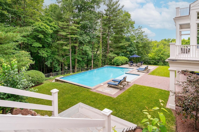 view of pool with a yard and a patio area