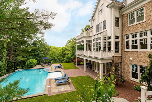 view of pool with a yard and a patio