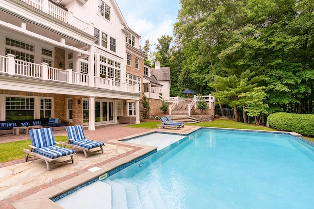 view of pool featuring outdoor lounge area and a patio