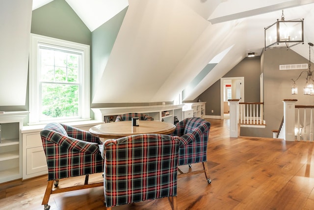 dining area featuring light hardwood / wood-style flooring and lofted ceiling