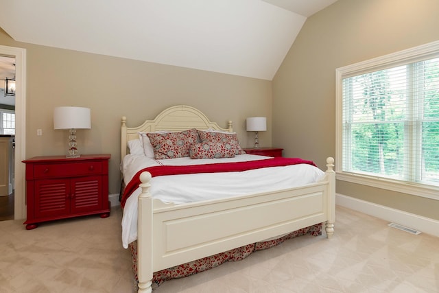 carpeted bedroom with lofted ceiling