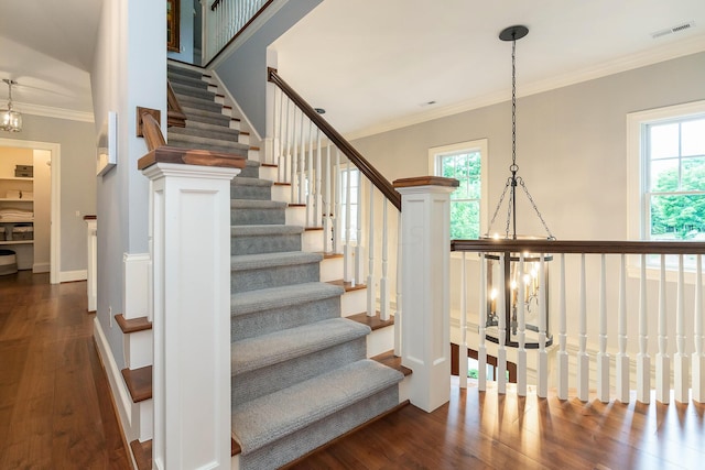 stairs featuring wood-type flooring and ornamental molding