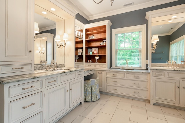 bathroom with tile patterned flooring, ornamental molding, vanity, and a healthy amount of sunlight