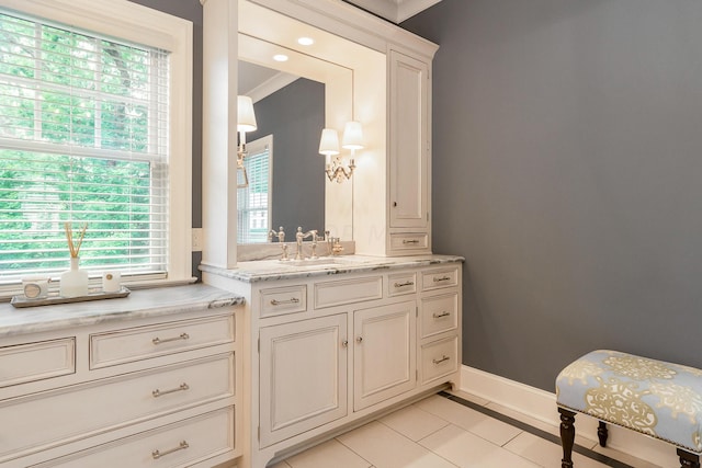 bathroom with crown molding, tile patterned flooring, and vanity