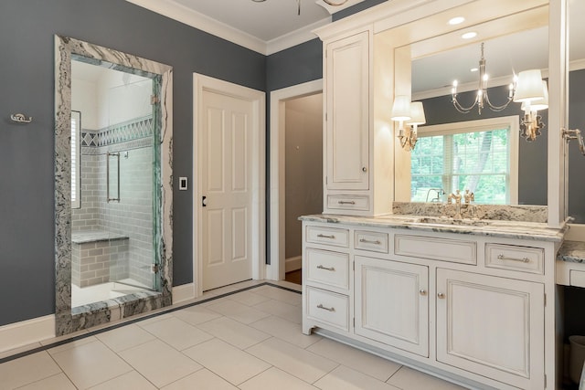 bathroom featuring tile patterned floors, crown molding, a chandelier, vanity, and a shower with shower door