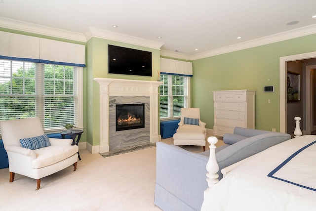 carpeted bedroom with ornamental molding and a premium fireplace