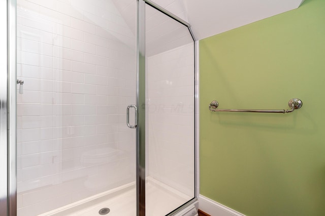 bathroom with a shower with door