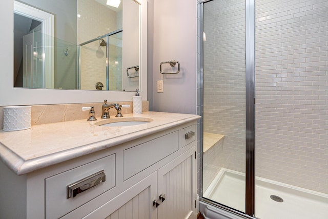 bathroom with vanity and a shower with shower door