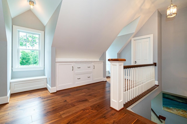 bonus room with lofted ceiling and dark hardwood / wood-style floors