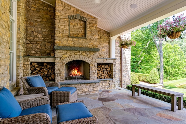 view of patio featuring an outdoor stone fireplace