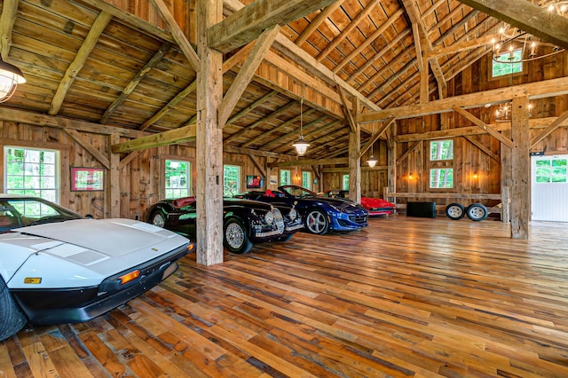 garage featuring wood ceiling and wood walls