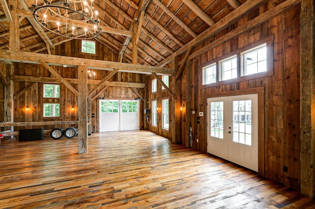 interior space with beamed ceiling, hardwood / wood-style floors, an inviting chandelier, and high vaulted ceiling