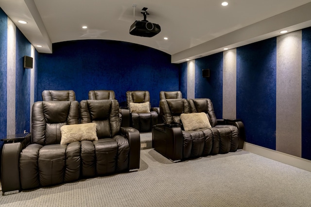 cinema with light colored carpet and lofted ceiling