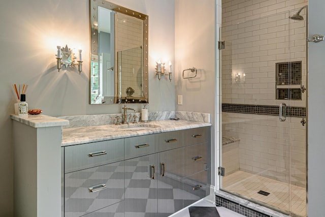 bathroom featuring vanity and a shower with shower door