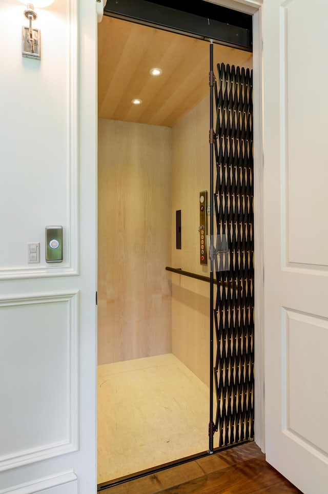 bathroom featuring hardwood / wood-style flooring and elevator