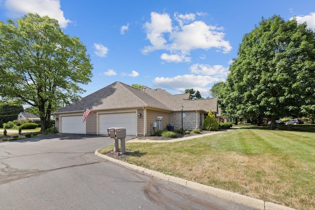 view of front of property featuring a garage and a front yard