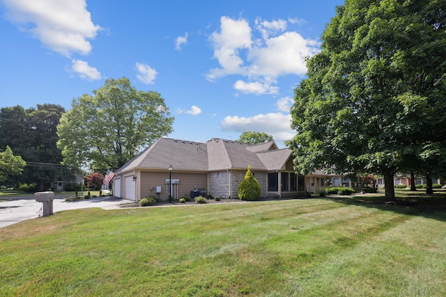 view of front of house featuring a garage and a front lawn