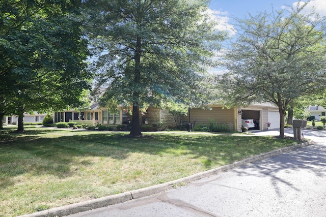 view of front of house with a garage and a front lawn