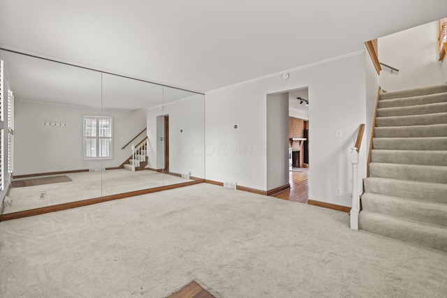 interior space featuring a brick fireplace and ornamental molding