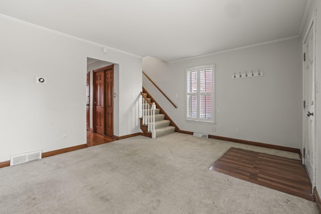 unfurnished room featuring carpet floors and crown molding