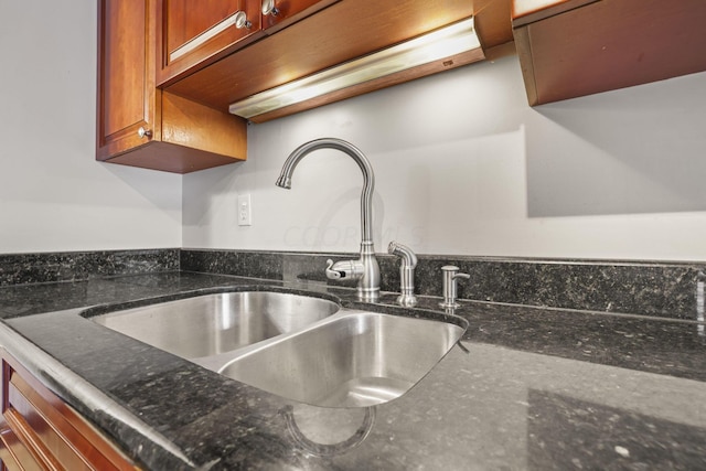 details with dark stone countertops and sink