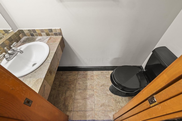 bathroom with tile patterned flooring, toilet, and sink