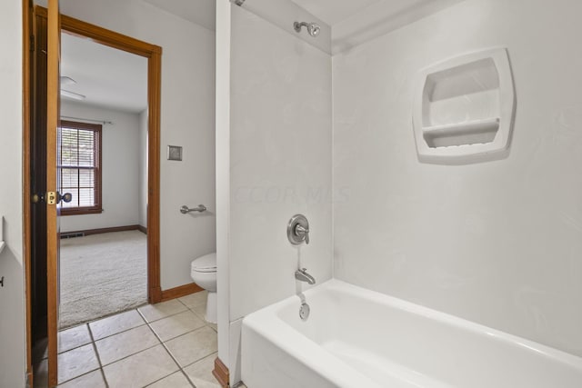 bathroom with tile patterned floors, toilet, and bathing tub / shower combination