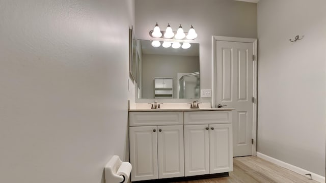 bathroom featuring a shower with door, vanity, and wood-type flooring