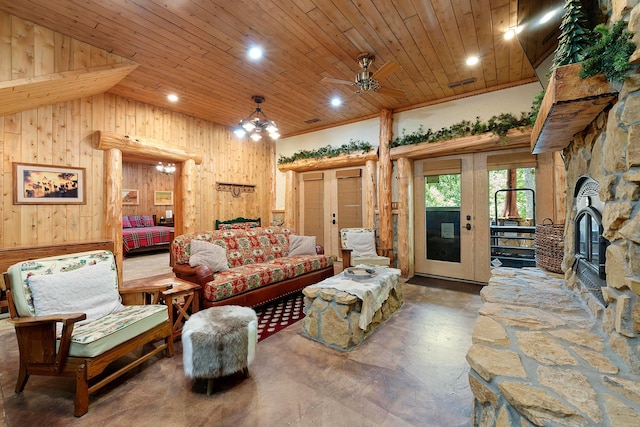 living room featuring french doors, wooden ceiling, vaulted ceiling, wooden walls, and ceiling fan with notable chandelier