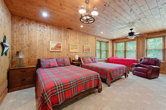 bedroom featuring wooden ceiling, light carpet, wooden walls, and multiple windows