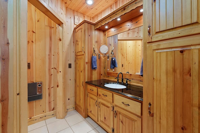 bathroom with tile patterned floors, vanity, wooden ceiling, and wooden walls