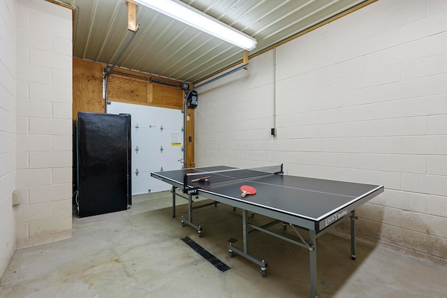 17441 Keister Rd, Laurelville, OH 43135 - rec room with unfinished concrete flooring, concrete block wall, and a garage