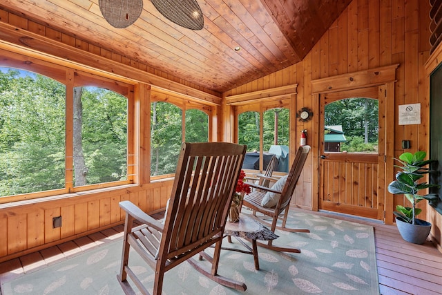 interior space with ceiling fan, vaulted ceiling, a wealth of natural light, and wood ceiling