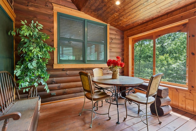 dining space with a wealth of natural light, light hardwood / wood-style floors, and lofted ceiling