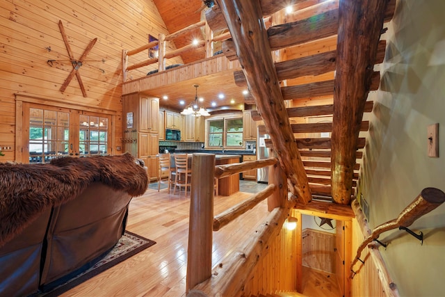 17441 Keister Rd, Laurelville, OH 43135 - living area featuring plenty of natural light, light wood-style flooring, wooden walls, high vaulted ceiling, and french doors
