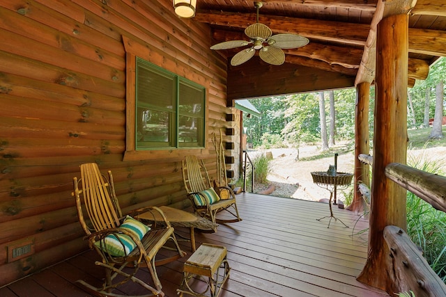 wooden deck featuring ceiling fan