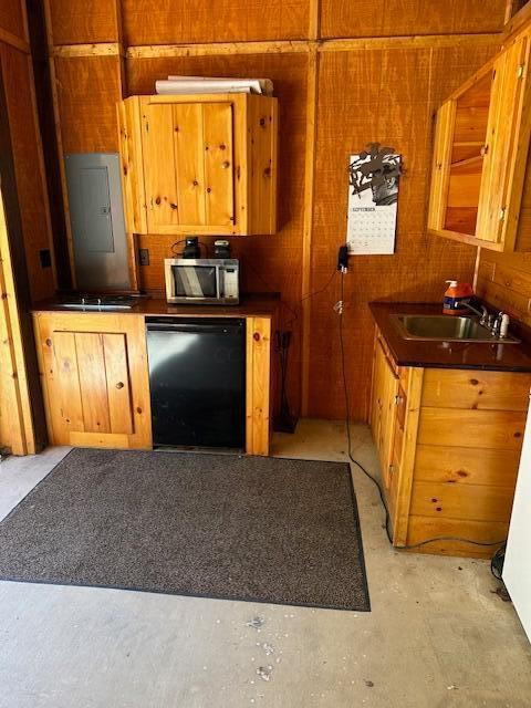 17441 Keister Rd, Laurelville, OH 43135 - kitchen with dishwasher, stainless steel microwave, dark countertops, brown cabinetry, and wood walls