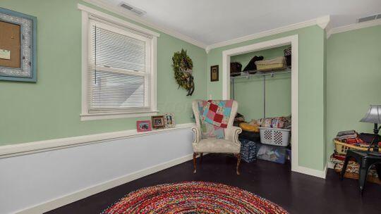 living area with crown molding