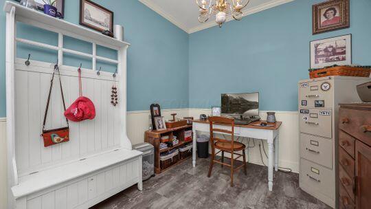 office with dark hardwood / wood-style flooring, a chandelier, and ornamental molding