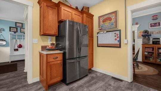 kitchen featuring stainless steel fridge and dark hardwood / wood-style floors