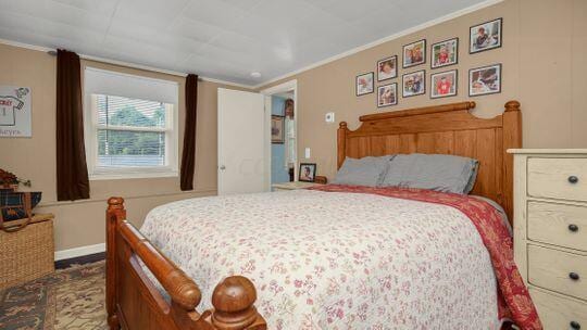 bedroom with ornamental molding