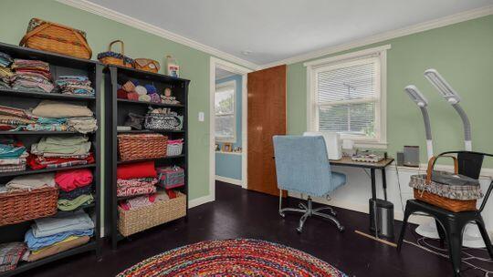 home office with crown molding, plenty of natural light, and hardwood / wood-style flooring