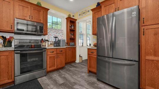 kitchen featuring decorative backsplash, dark hardwood / wood-style floors, and stainless steel appliances