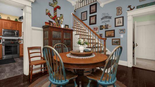 dining space featuring dark hardwood / wood-style floors and crown molding