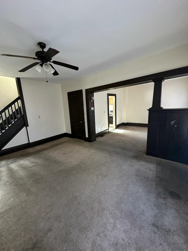 carpeted empty room featuring ceiling fan