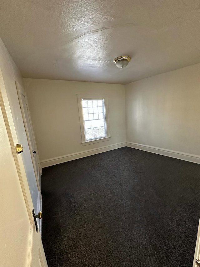 spare room with a textured ceiling