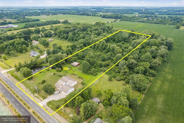 birds eye view of property featuring a rural view and a water view