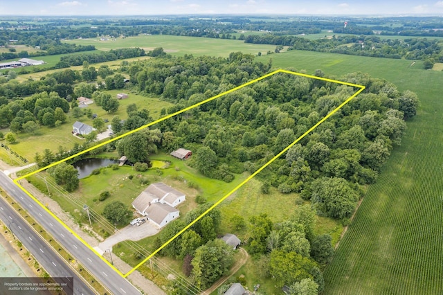 birds eye view of property with a rural view and a water view