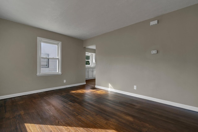 unfurnished room featuring dark hardwood / wood-style flooring