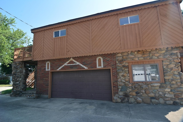 view of side of home featuring a balcony and a garage